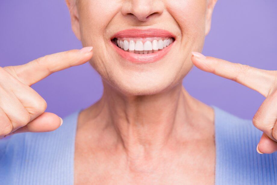 Older Female Showing Healthy White Teeth